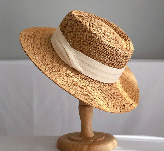 straw hat with white band on a stand display
