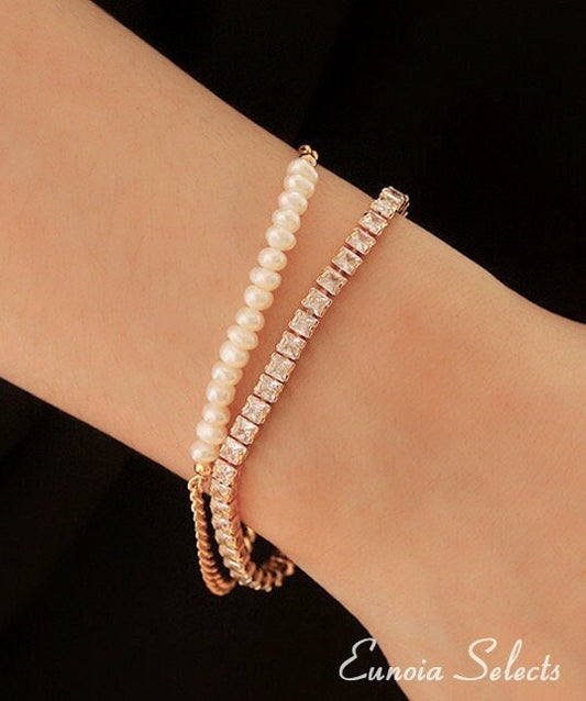 tennis bracelet women and pearl bracelet on a wrist