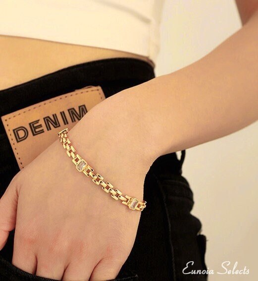 model wearing thin gold watch band link chain bracelet