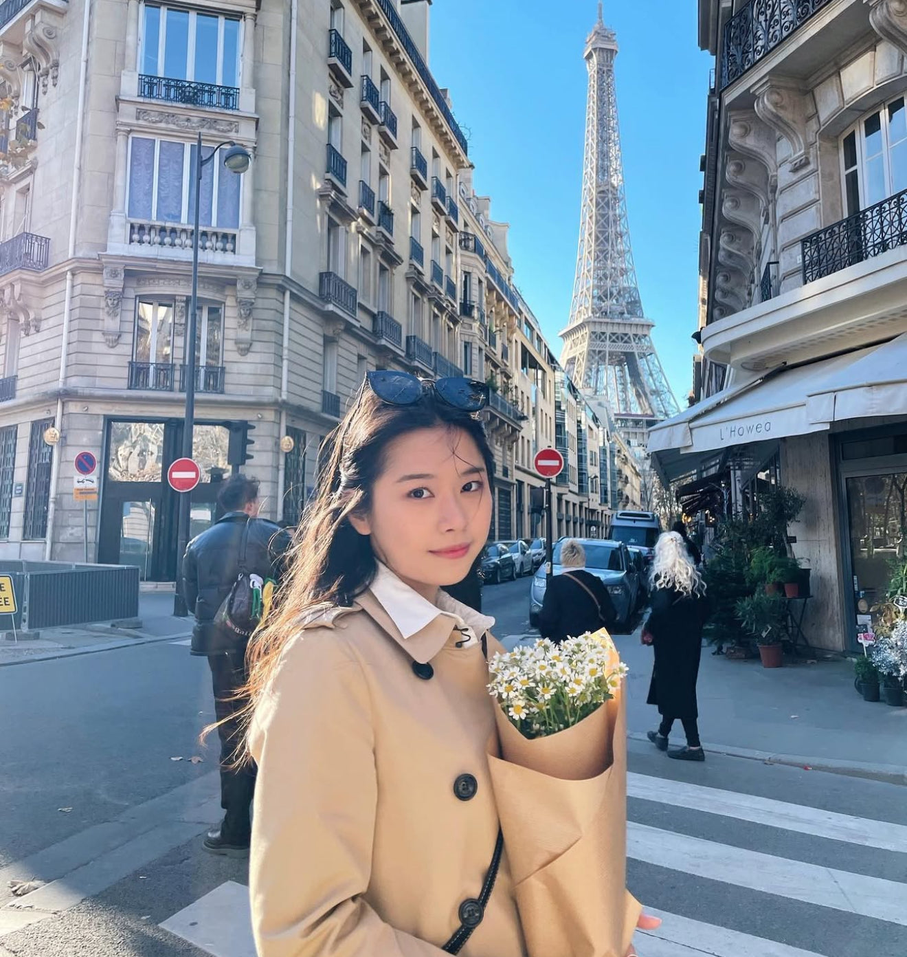 Genevieve Cen standing on a street in Paris with the Eiffel Tower in the background
