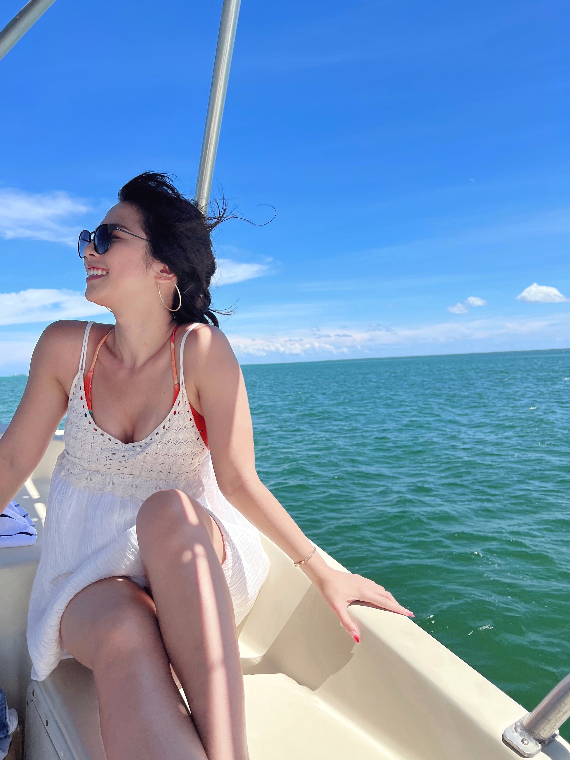 Model wearing Zoe Oversize hoops on a boat