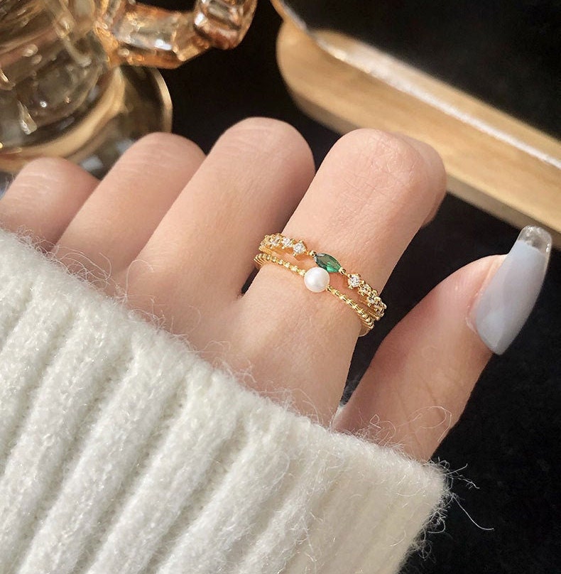 model wearing emerald gold ring