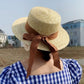 straw hat with brown ribbon