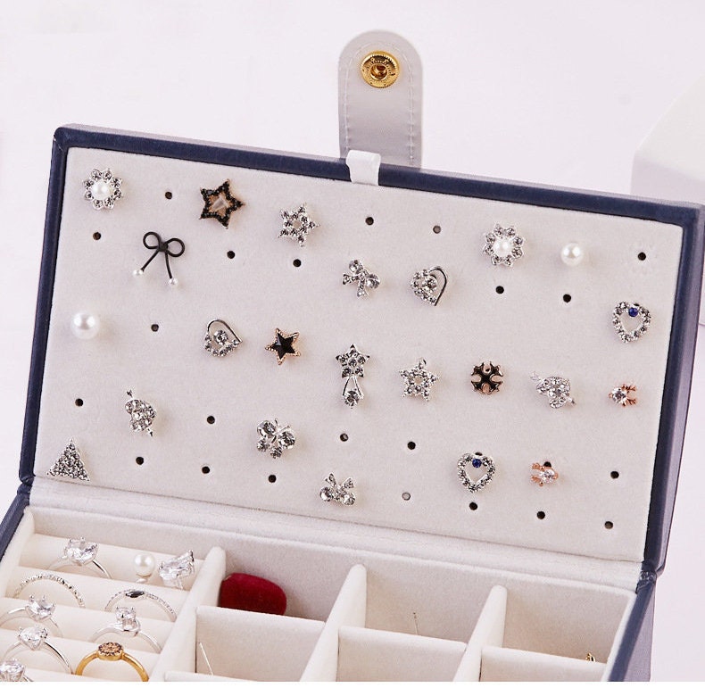 multiple earrings can be stored inside leather travel jewelry case