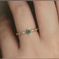 model wearing vintage wedding ring on hand, May birthstone 