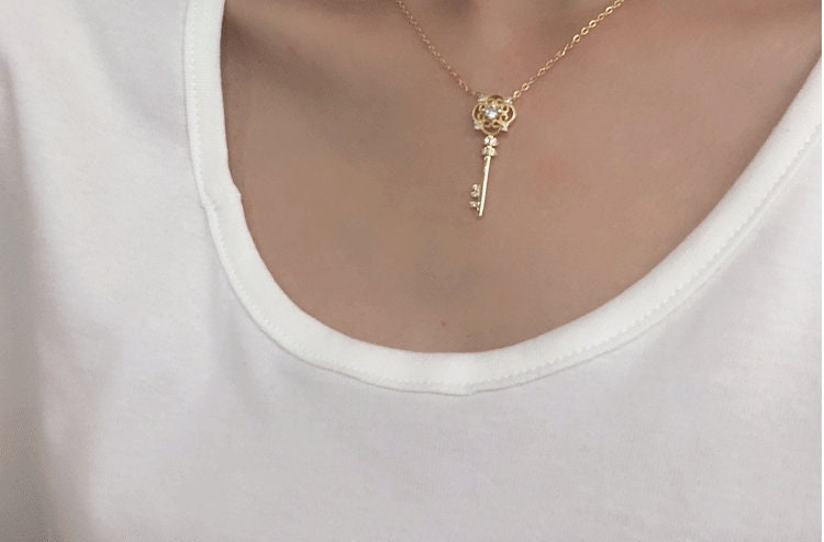model wearing aesthetic gold key necklace for women