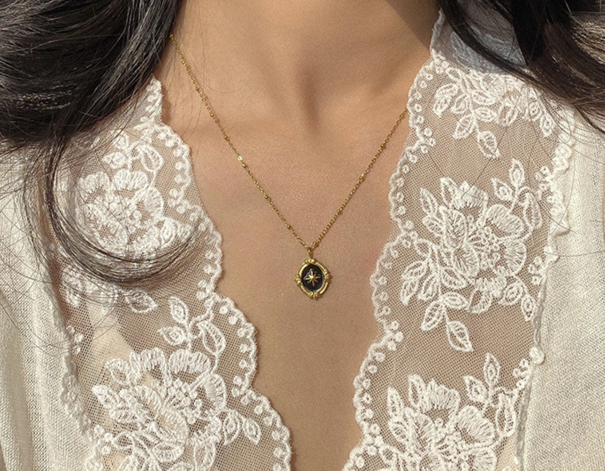 model wearing black gold oval coin pendant necklace