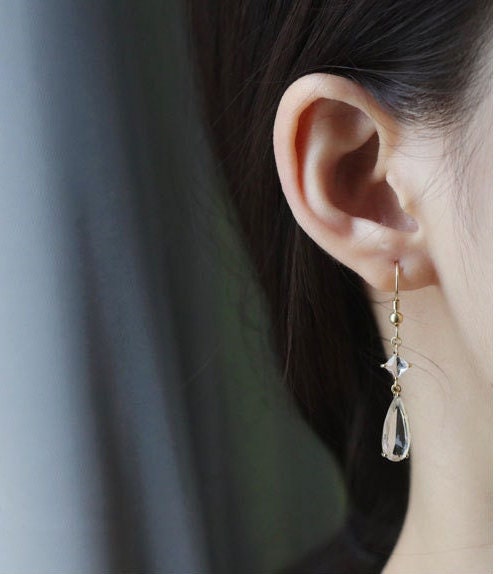 model wearing antique gold earrings