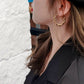 model wearing medium size twisted gold hoops minimalist earrings