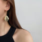 model wearing dangle earrings