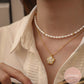 model wearing white pearl necklace and floral pendant